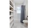 Bright bathroom features a shower/tub combination, storage shelves, and a classic subway tile surround at 1514 Rogers Sw Ave, Atlanta, GA 30310