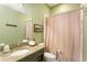 This bathroom features a shower and tub combination, granite countertops, and a neutral color scheme at 1514 Rogers Sw Ave, Atlanta, GA 30310