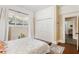 Bright bedroom with hardwood floors, fresh paint, and large windows, closet, and interior entry at 1514 Rogers Sw Ave, Atlanta, GA 30310