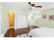 This bedroom features a ceiling fan, hardwood floors, a colorful rug, and access to an ensuite bathroom at 1514 Rogers Sw Ave, Atlanta, GA 30310