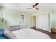 Well-lit bedroom features a ceiling fan, closet, and easy access to the exterior of the property at 1514 Rogers Sw Ave, Atlanta, GA 30310