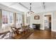 Dining room featuring hardwood floors, coffered ceilings, large windows, and modern chandelier at 1514 Rogers Sw Ave, Atlanta, GA 30310