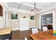 Dining room featuring hardwood floors, a white brick fireplace, modern art, and view to living room at 1514 Rogers Sw Ave, Atlanta, GA 30310