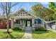 Inviting craftsman home with blue facade, stone porch columns, and mature landscaping at 1514 Rogers Sw Ave, Atlanta, GA 30310
