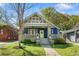 Attractive home with blue brick, stone porch columns, a yellow front door, and a manicured lawn at 1514 Rogers Sw Ave, Atlanta, GA 30310