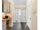 Hallway features gray tile floor, built-in wine rack, and access to a bathroom, back hallway, and front door at 1514 Rogers Sw Ave, Atlanta, GA 30310
