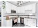 Bright kitchen features gray tile floor, stainless steel appliances, granite counters, and white cabinets at 1514 Rogers Sw Ave, Atlanta, GA 30310