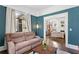 Cozy living room with refinished hardwood floors, an open floorplan, and teal walls at 1514 Rogers Sw Ave, Atlanta, GA 30310
