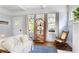Bright living room with refinished hardwood floors, neutral paint, rocking chair, and beautiful natural light at 1514 Rogers Sw Ave, Atlanta, GA 30310