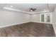 Spacious finished basement with wood-look tile flooring and double doors at 247 Old Timber Rd, Lawrenceville, GA 30046