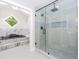 Bright bathroom featuring a glass shower enclosure with a tiled backdrop and an adjacent soaking tub at 247 Old Timber Rd, Lawrenceville, GA 30046