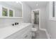 Bright bathroom featuring a white vanity with modern black faucet and a glass-enclosed shower at 247 Old Timber Rd, Lawrenceville, GA 30046