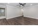 Bedroom featuring modern floors, fan, and adjoining bathroom with shower at 247 Old Timber Rd, Lawrenceville, GA 30046