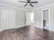 Spacious bedroom with closet, en-suite bathroom, wood-look floors, neutral walls, and a ceiling fan at 247 Old Timber Rd, Lawrenceville, GA 30046