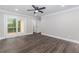 Bedroom with modern floors, fan, and private balcony access at 247 Old Timber Rd, Lawrenceville, GA 30046