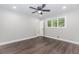 Bright bedroom featuring wood-look floors, neutral walls, a ceiling fan, and a window for natural light at 247 Old Timber Rd, Lawrenceville, GA 30046