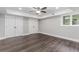 Bedroom featuring dark wood-look tile floors, white trim, and double-door closet at 247 Old Timber Rd, Lawrenceville, GA 30046