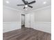 Bedroom featuring dark wood-look floors, neutral walls, ceiling fan, and closet at 247 Old Timber Rd, Lawrenceville, GA 30046
