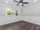 Bedroom with dark wood-look floors, neutral walls, and a ceiling fan, creating a calming atmosphere at 247 Old Timber Rd, Lawrenceville, GA 30046