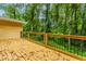 A wood deck has a beautiful view of the lush green yard and mature trees at 247 Old Timber Rd, Lawrenceville, GA 30046