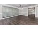 Bright dining room with wood floors, wainscoting, a modern chandelier, and a stylish glass block wall at 247 Old Timber Rd, Lawrenceville, GA 30046