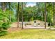 Inviting single-story home with stone accents and a two-car garage surrounded by lush greenery and mature trees at 247 Old Timber Rd, Lawrenceville, GA 30046