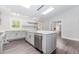 Modern kitchen featuring an island, stainless steel appliances, and lots of natural light at 247 Old Timber Rd, Lawrenceville, GA 30046