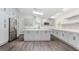 Bright open kitchen with stainless steel appliances, island with sink, and modern gray cabinets at 247 Old Timber Rd, Lawrenceville, GA 30046