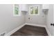 Well-lit laundry room with white walls, matching cabinets, and modern flooring at 247 Old Timber Rd, Lawrenceville, GA 30046