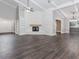 Spacious living room with vaulted ceilings, a stone fireplace, and wood floors, offering a bright and airy feel at 247 Old Timber Rd, Lawrenceville, GA 30046