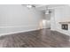 Bright living room with wood floors, vaulted ceilings, a stone fireplace, and an open layout for comfortable living at 247 Old Timber Rd, Lawrenceville, GA 30046