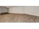 Neutral room features modern flooring, white painted paneling, and an exterior door at 247 Old Timber Rd, Lawrenceville, GA 30046