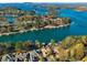 Stunning aerial view of lakefront home with private dock and lake access in a beautiful community at 6316 Woodlake Dr, Buford, GA 30518