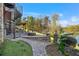 Landscaped backyard with stone walkway, fire pit, spiral staircase, and scenic lake views at 6316 Woodlake Dr, Buford, GA 30518