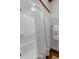 Clean bathroom with a white shower curtain and classic wood trim at 6316 Woodlake Dr, Buford, GA 30518