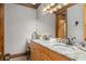 Bathroom features double sinks with granite counters, wood cabinets, and a large mirror at 6316 Woodlake Dr, Buford, GA 30518