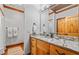 Bathroom featuring granite counters, wood cabinets, and modern fixtures at 6316 Woodlake Dr, Buford, GA 30518