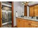 Bathroom features double sinks with granite counters, wood cabinets, and a large mirror at 6316 Woodlake Dr, Buford, GA 30518