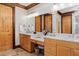 Bathroom with double sink vanity, great lighting, ample storage and wood trim and door at 6316 Woodlake Dr, Buford, GA 30518