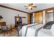 Relax in this inviting bedroom with wood floors, ceiling fan, and abundant natural light at 6316 Woodlake Dr, Buford, GA 30518
