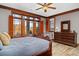 Relax in this inviting bedroom with wood floors, ceiling fan, and abundant natural light at 6316 Woodlake Dr, Buford, GA 30518