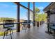 Inviting covered deck boasts lake views, wood columns, plank flooring, and bar seating at 6316 Woodlake Dr, Buford, GA 30518