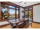 Inviting dining room with hardwood floors, large windows showcasing a lake view, and wood trim at 6316 Woodlake Dr, Buford, GA 30518