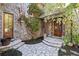 Charming stone home entrance with a stone walkway and a wooden double door at 6316 Woodlake Dr, Buford, GA 30518