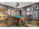 Spacious game room features a pool table, bar area, and sports memorabilia for entertaining at 6316 Woodlake Dr, Buford, GA 30518