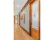 Elegant hallway with hardwood floors, wood trim, and a decorative pantry door at 6316 Woodlake Dr, Buford, GA 30518