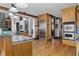 Bright kitchen with stainless steel appliances, wood cabinetry, granite countertops, and hardwood floors at 6316 Woodlake Dr, Buford, GA 30518