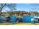 Lakeside view showing multiple docks and boats on the lake framed by the shoreline and trees at 6316 Woodlake Dr, Buford, GA 30518