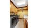 Functional laundry room boasts tile flooring, built-in cabinets, and modern washer/dryer at 6316 Woodlake Dr, Buford, GA 30518