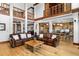 Open-concept living room featuring hardwood floors, two leather couches, and soaring ceilings at 6316 Woodlake Dr, Buford, GA 30518